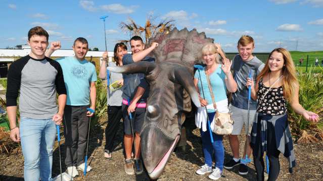 People with mini golf clubs at Dinosaur Escape in Northolt