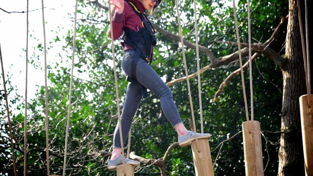 Girl on high rope course at Skywalk Adventure in Esher