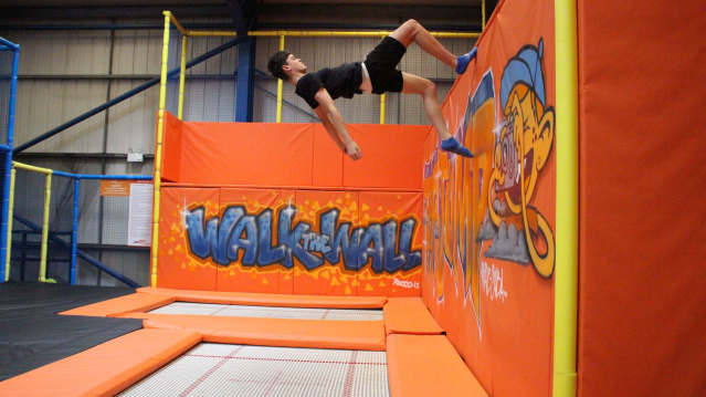 Guy jumping off wall at TopJump Trampoline Park in Milton Keynes