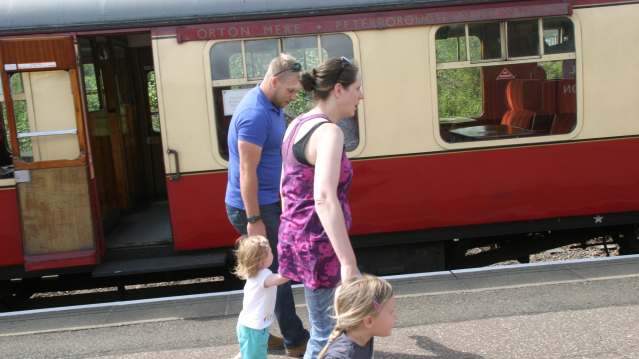 Family alongside train at Nene Valley Railway in Peterborough