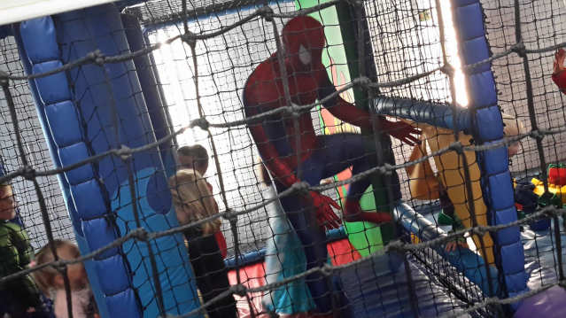 Kids and Spiderman playing on soft play frame at Whale of a Time in Cambridge