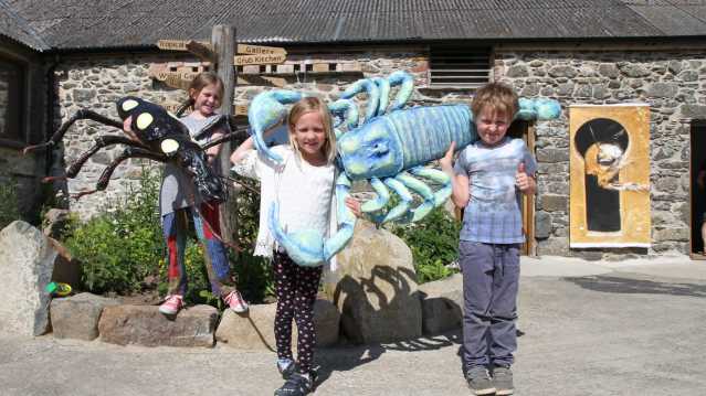 Kids next to bugs sculptures at Dr Beynon's Bug Farm in St Davids