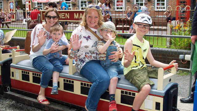 Family on miniature train at Mizens Railway in Woking