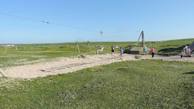 Girl on zip wire at Eoropie Dunes Playpark in Isle of Lewis