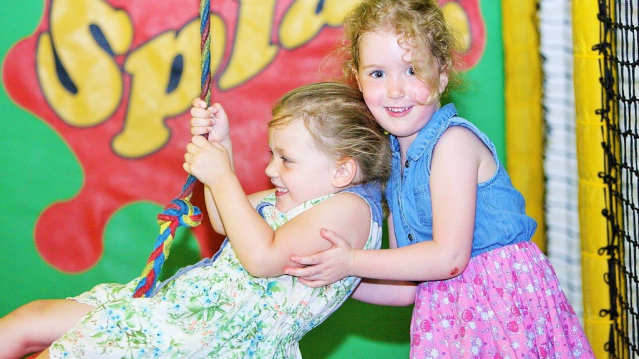 Girls on play swing at Wild n Wacky in Harlow