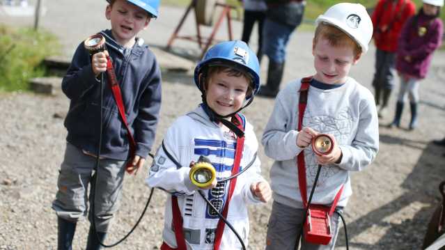 Kids with helmets and torches at Killhope Lead Mining Museum in Bishop Auckland