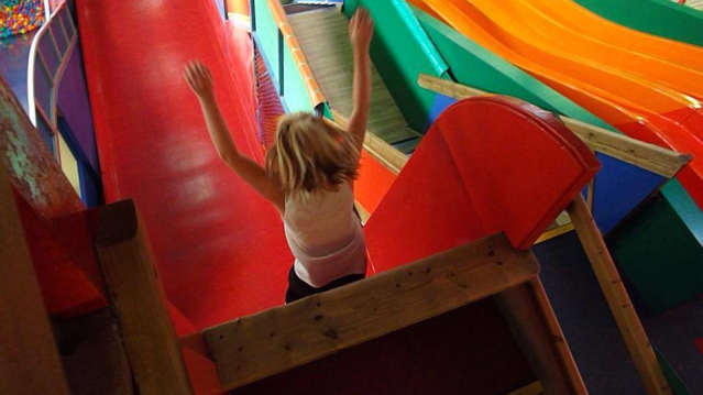 Girl on slide at Playzone Indoor Soft Play Centre in Swansea
