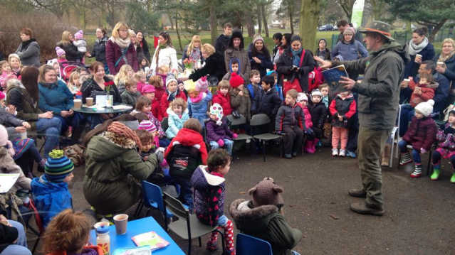 Man telling story to families at Embankment Gardens and Russell Park in Bedford