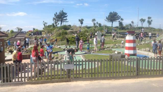 Families play mini golf at Sandbanks Crazy Golf in Poole
