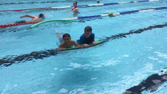 Boys swimming with bouyancy aid at Levenmouth Swimming Pool