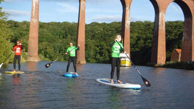 Kids on paddle boards at Whitby Surf School