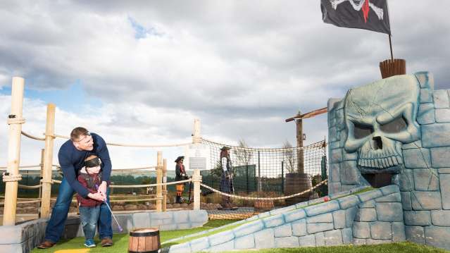 Dad and son play golf at Pirates Island Adventure Golf in Blofield