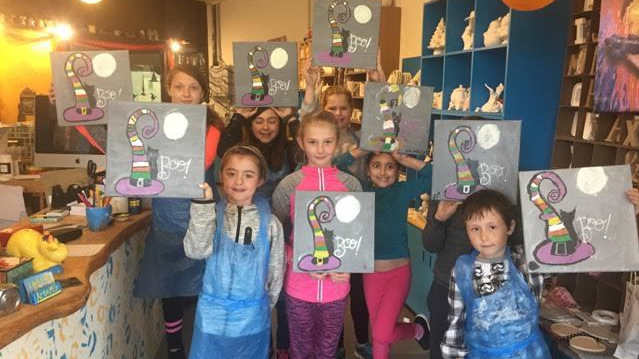 Kids with painted hats at Art and Mor Paint Your Own Pottery in Kenmare