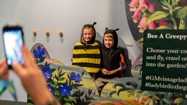 Two children having their photo taken while dressed up 