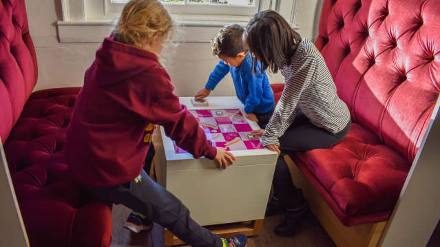 Three children play a game at Headstone Manor and Museum 