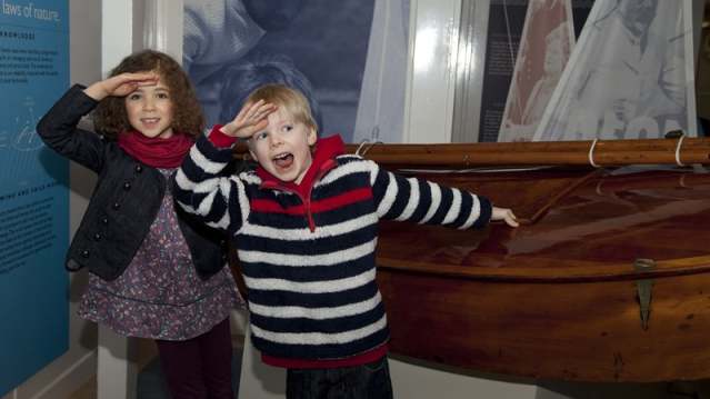 Kids by model boat at The Royal Yacht Britannia in Edinburgh
