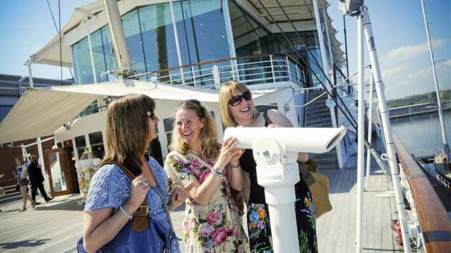 Women using telescope at The Royal Yacht Britannia in Edinburgh