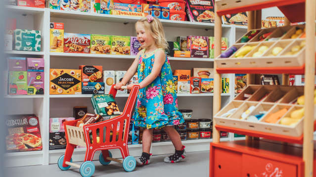 A little girl playing with a trolley at Curious Kids Town. Image credit: Curious Kids Town website