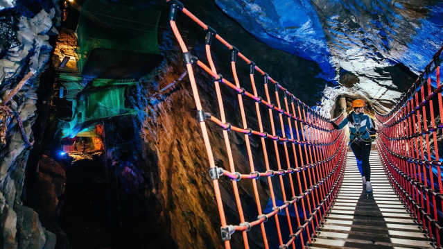 Visitors exploring the Victorian slate mine at Zip World Llechwedd
