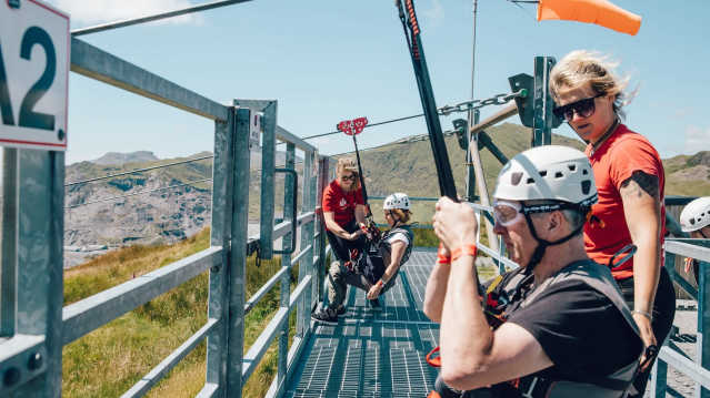 Visitors preparing for the seated zip line at Zip World Llechwedd