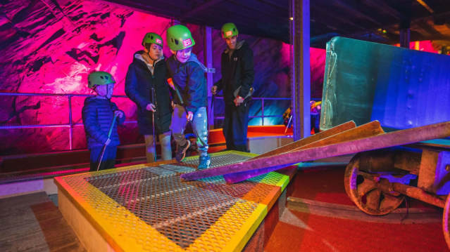 Family playing Underground Golf inside the caverns at Zip World Llechwedd