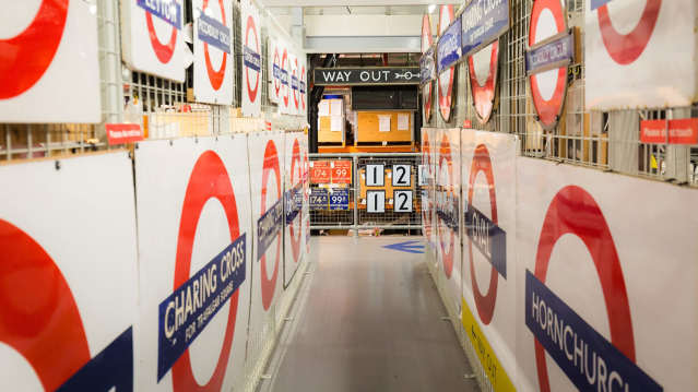 Row of vintage London Underground station signs on display at London Transport Museum .