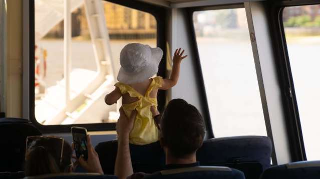 man holding a child up on the boat ride