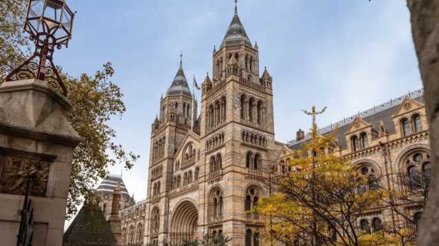 View of the front of the Natural History Museum's historical building against the blue sky