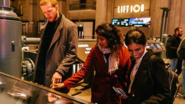 adults looking at interactive elements are lift 109 battersea power station