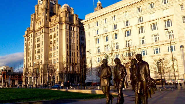 Beatles statue at Liverpool Pier Head with the Royal Liver Building in the background.