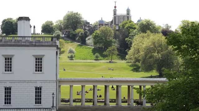 Tourists posing for photos on the Prime Meridian Line at Royal Observatory Greenwich
