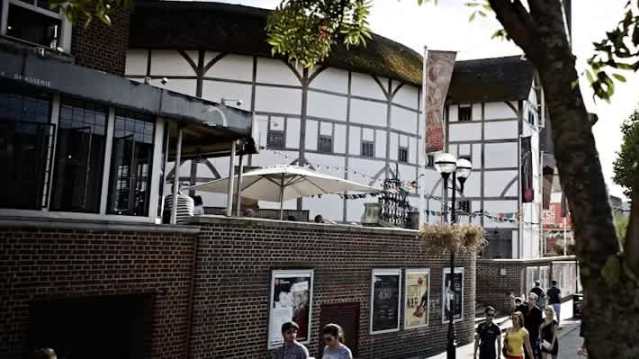 Historic stage and open roof inside Shakespeare’s Globe Theatre.