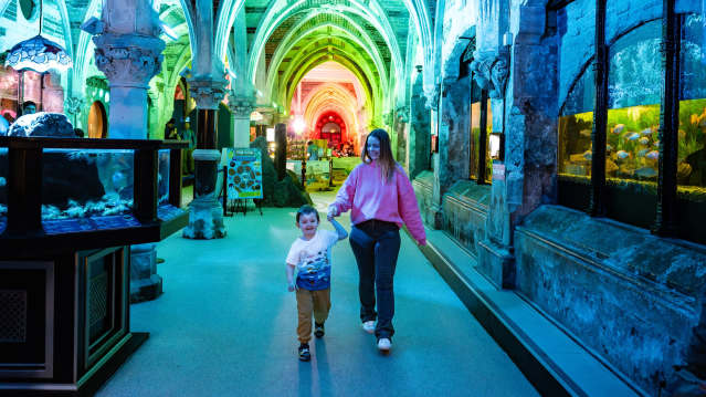 mum and son walking through sea life