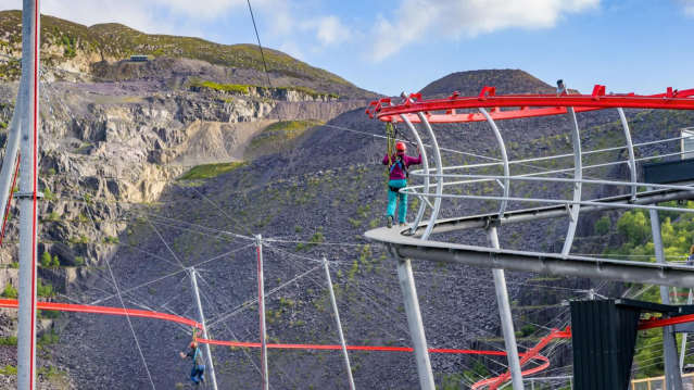 Rider soaring head-first on the Velocity 2 zipline over Penrhyn Quarry