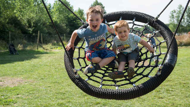 Families enjoying the outdoor farm park at Lotmead Farm and PYO, Swindon, Wiltshire